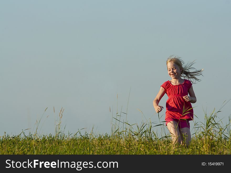 Little Girl Runs On Meadow In Summer