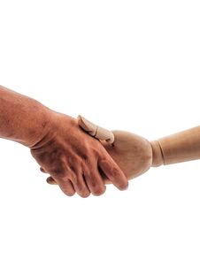 The Hands Of The Wooden Doll Are Holding On To The Human Hand On White Background Royalty Free Stock Images