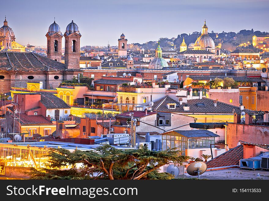 Colorful rooftops of Eternal city of Rome at dusk view