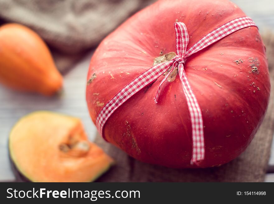 Red pumpkin tied with a ribbon. Red pumpkin tied with a ribbon