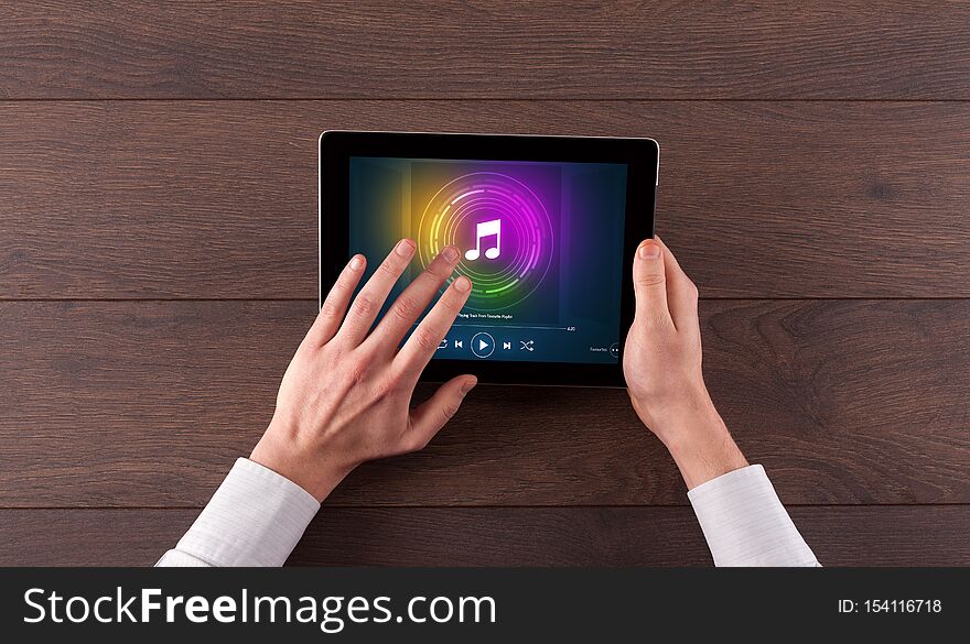 Hand holding tablet with music play concept