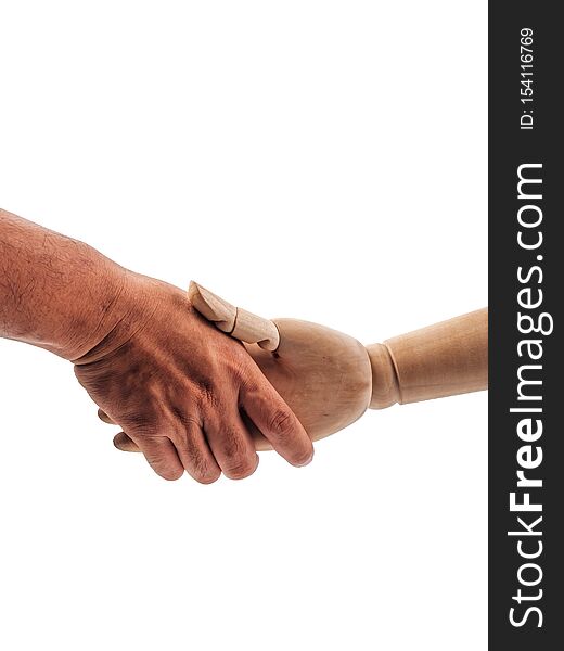 The hands of the wooden doll are holding on to the human hand on white background