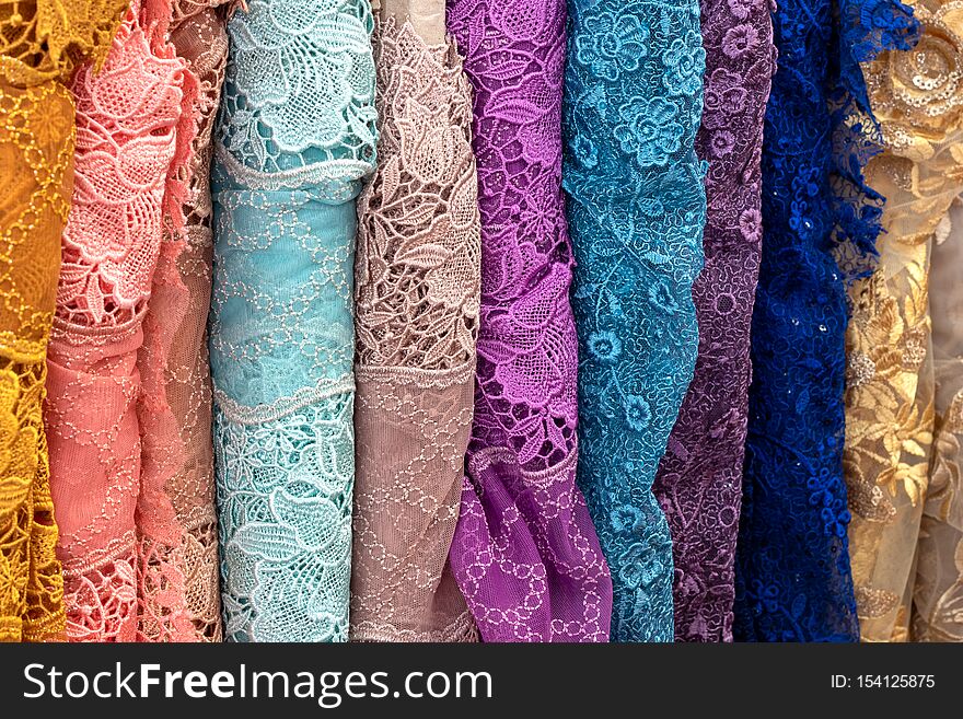 Close-up background, textured pattern, Thai fabric, floral pattern, various colors, colorful, which folds, rolls and overlaps vertically. Close-up background, textured pattern, Thai fabric, floral pattern, various colors, colorful, which folds, rolls and overlaps vertically