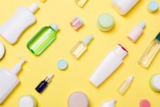 Top View Of Different Cosmetic Bottles And Container For Cosmetics On Yellow Background. Flat Lay Composition With Copy Space Stock Photo