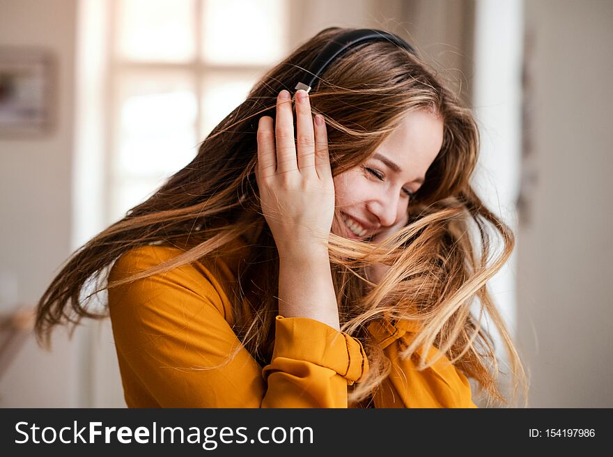 A young female student with headphones having fun.