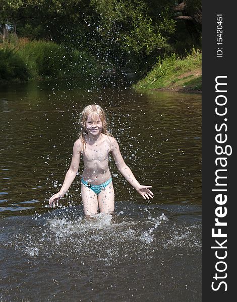 Little girl splashes with water