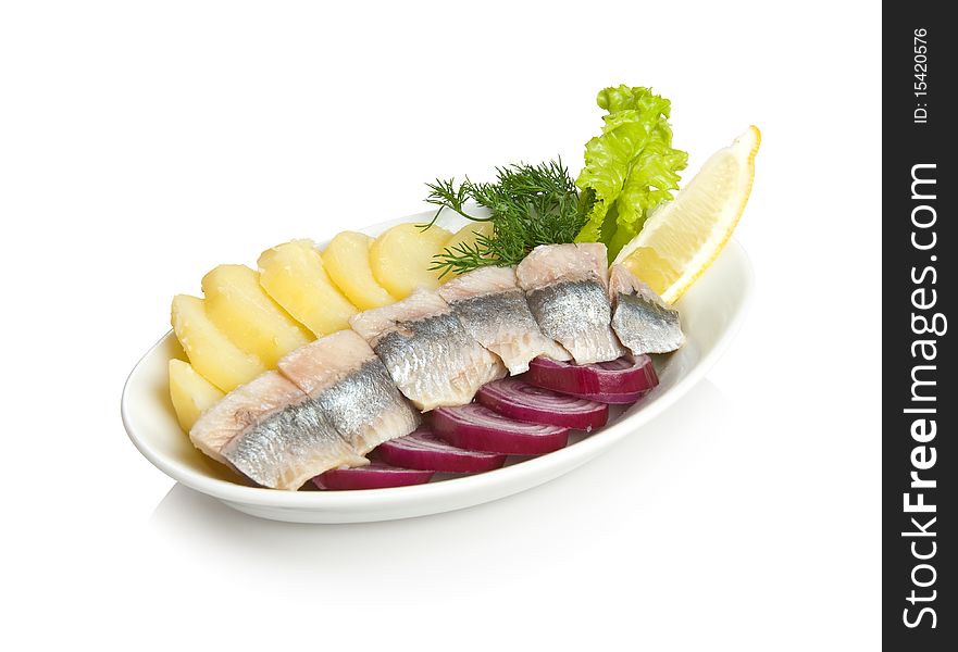 Norwegian herring appetizer with slices of potato and onion. Isolated on white.