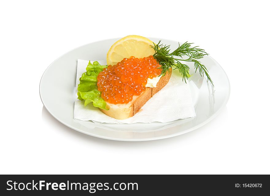 Open sandwich with red caviar, lettuce, lemon and dill.
Isolated on white.