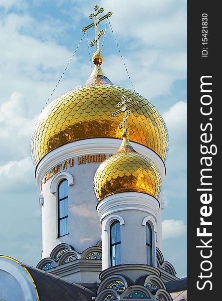 Gold domes of Orthodox Church with cross