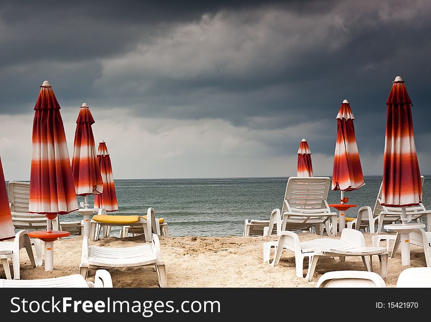 Beach with deckchairs and parasols sea