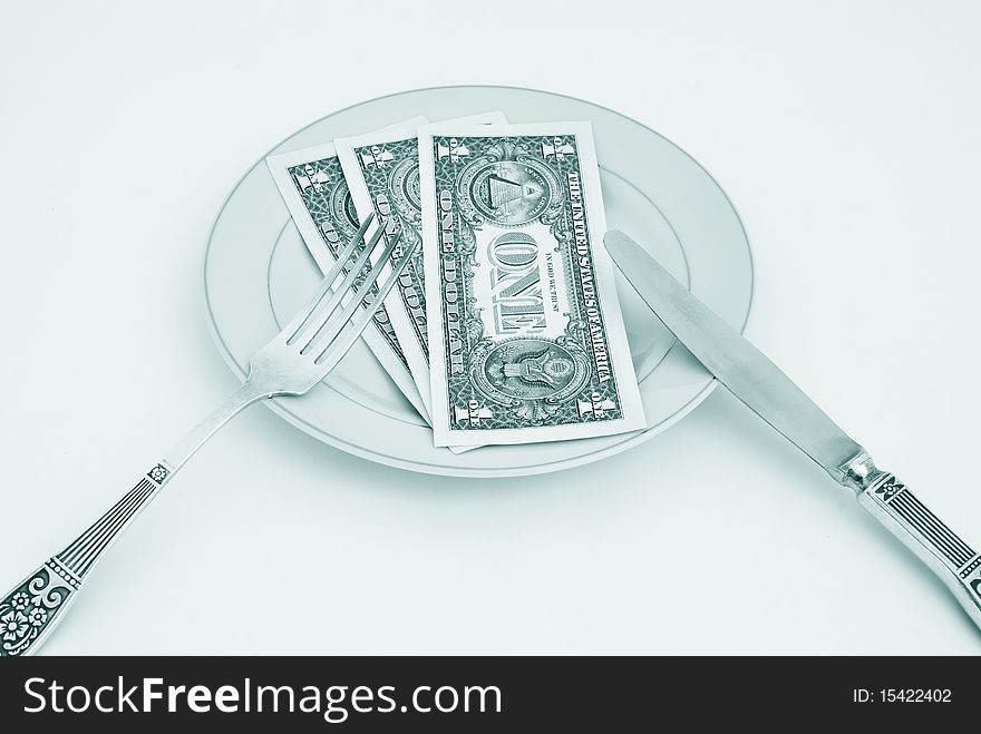 Dinner service with dollar denominations on plate. Dinner service with dollar denominations on plate.