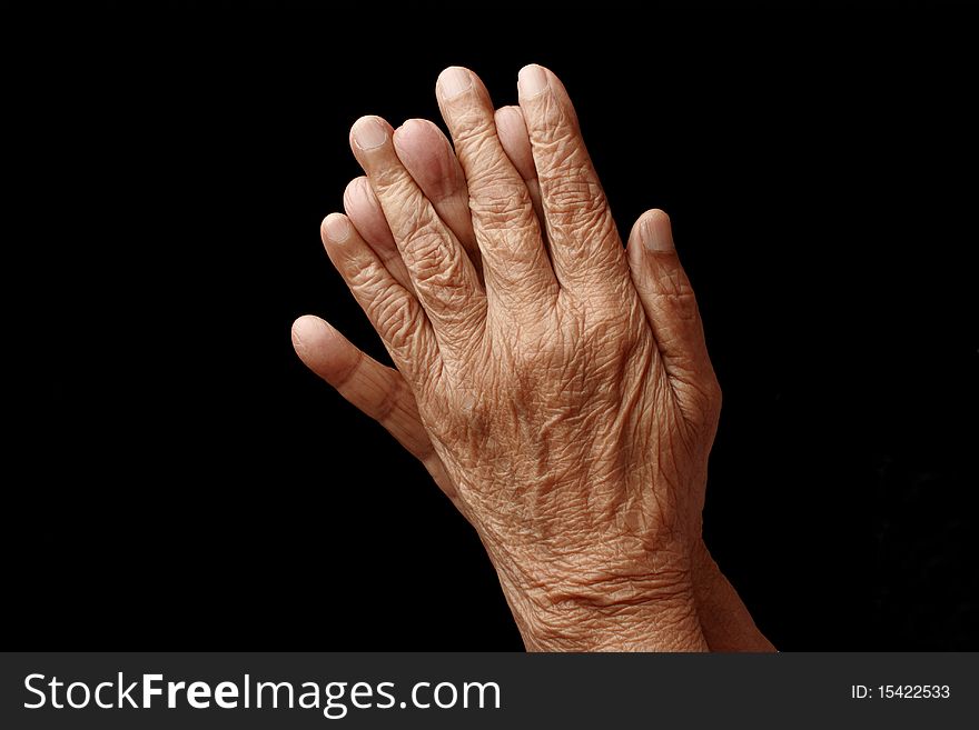 Praying hands of an old woman