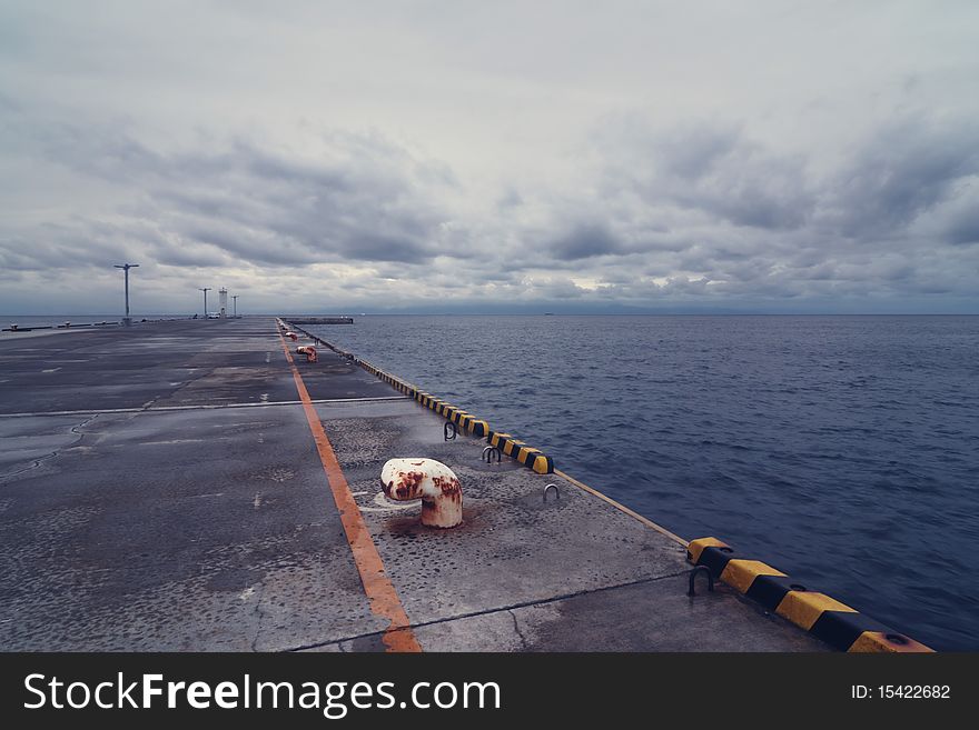 Empty  pier with stormy cloudy sky over Pacific Ocean. Empty  pier with stormy cloudy sky over Pacific Ocean