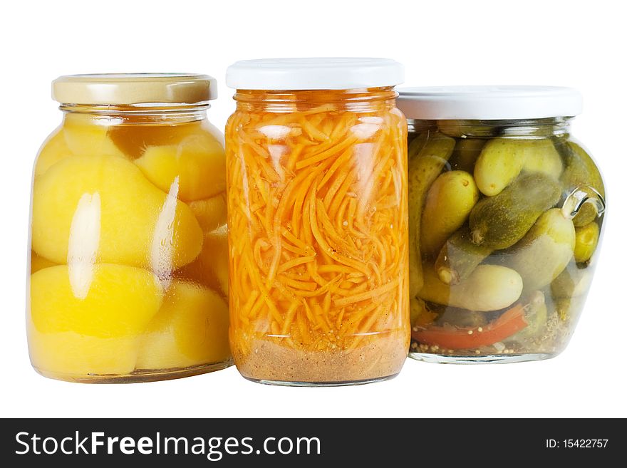 Banks canned apricots, cucumbers and carrots on a white background