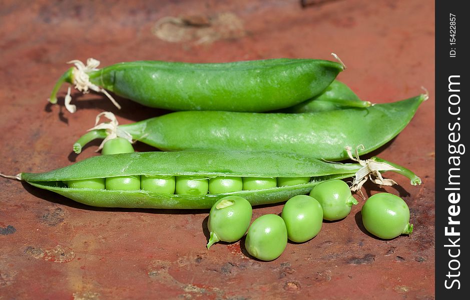 Pod green peas brown background