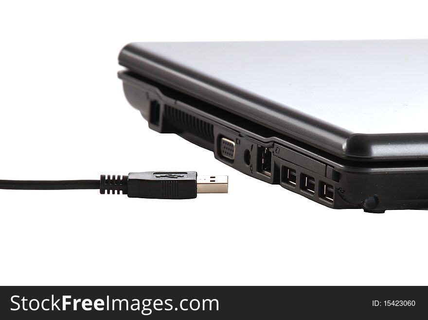 Close-up view of a USB connector by a laptop computer's USB ports.  Isolated on white. Close-up view of a USB connector by a laptop computer's USB ports.  Isolated on white.