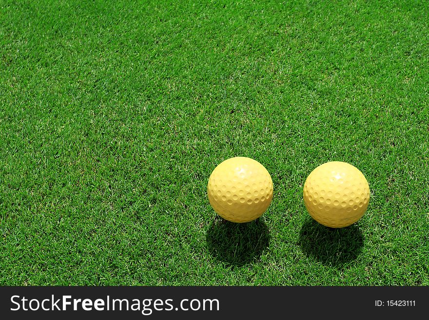 Two ceramic golf ball on green grass