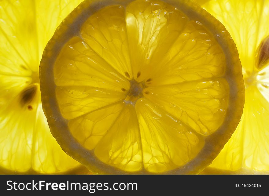 Lemon slices against hard light, very bright image. Lemon slices against hard light, very bright image