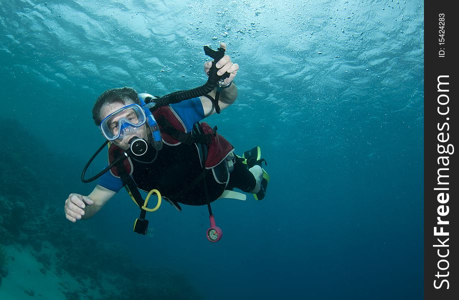 Man scuba diving in clear blue water. Man scuba diving in clear blue water