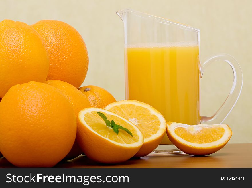 Bunch of oranges and a pitcher of orange juice. Bunch of oranges and a pitcher of orange juice