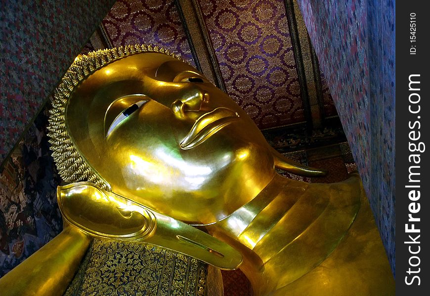 Beautiful Reclining Buddha Wat Pho Bangkok Thailand .The buddha in golden tone color.