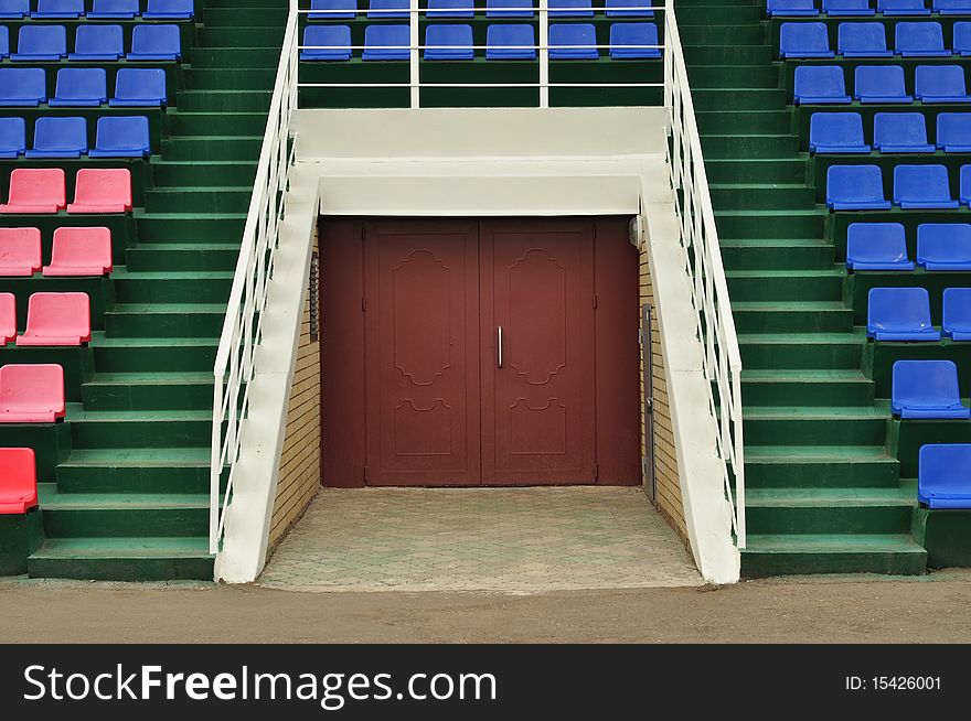 The doors and seats for spectators on the side, colored plastic chairs. The doors and seats for spectators on the side, colored plastic chairs