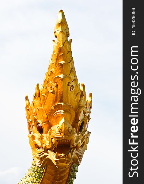 Close up of the golden naga or dragon shot with thai style art in front side. Close up of the golden naga or dragon shot with thai style art in front side