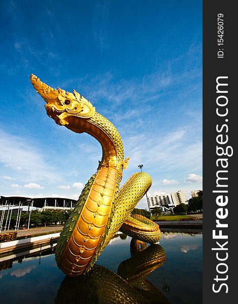 Full body of golden naga or dragon statue in front view. Full body of golden naga or dragon statue in front view