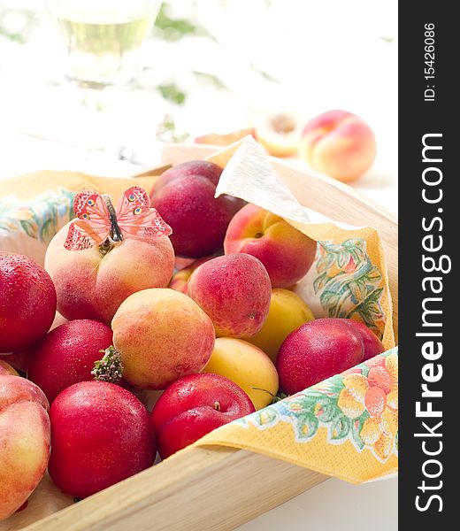 Fresh plums and apricots in bowl with butterfly. Fresh plums and apricots in bowl with butterfly
