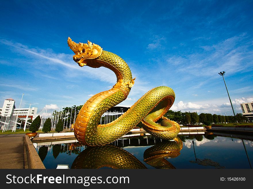 Full body of golden naga or dragon statue in side view. Full body of golden naga or dragon statue in side view