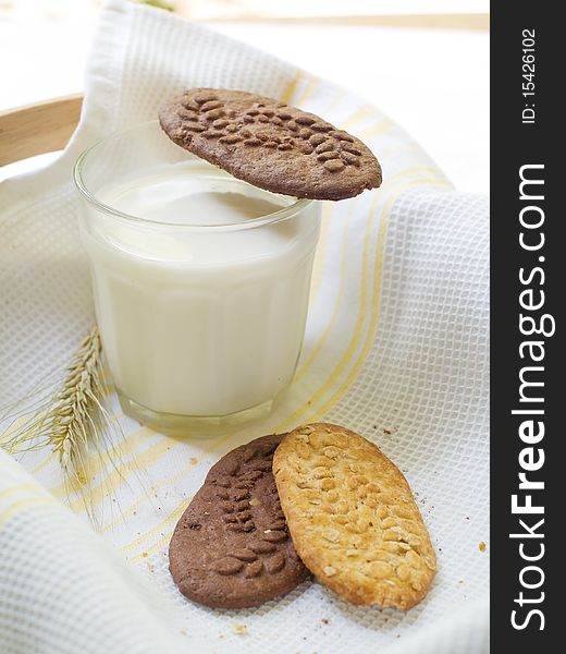 Glass of milk and cookies on light kitchen towel. Glass of milk and cookies on light kitchen towel