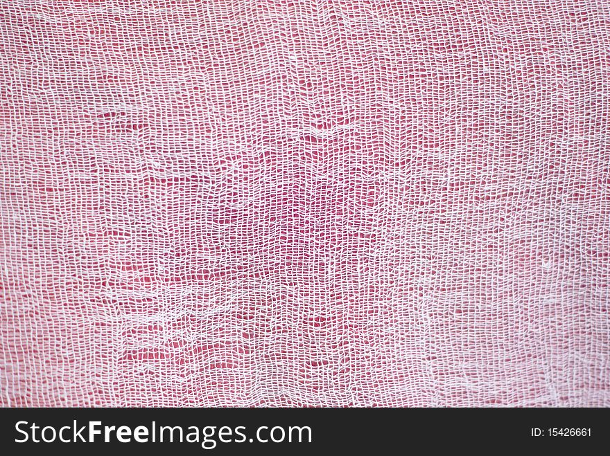 Background of white cotton mesh over red background