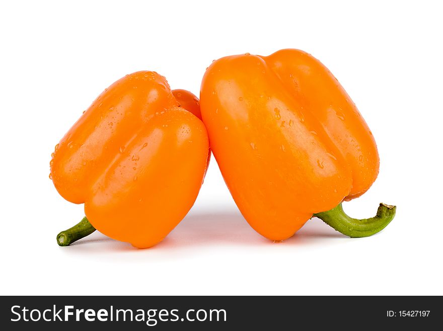 Orange paprika with drops of water, isolated on white background