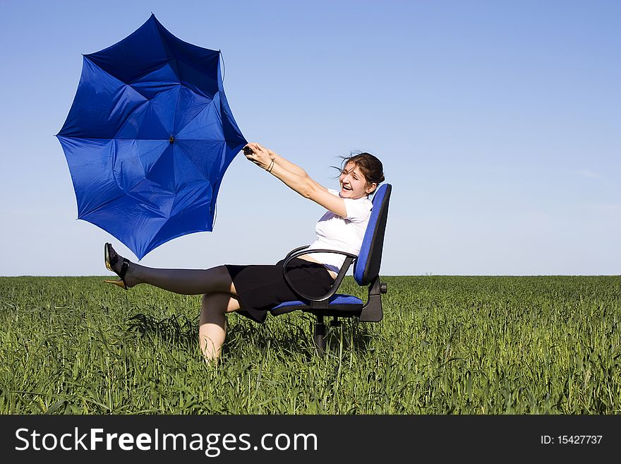 Business women with an umbrella on a grass land. Business women with an umbrella on a grass land