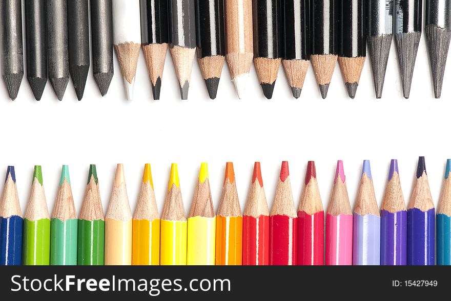 Collection of very brightly colored pencils opposing black and white pencils