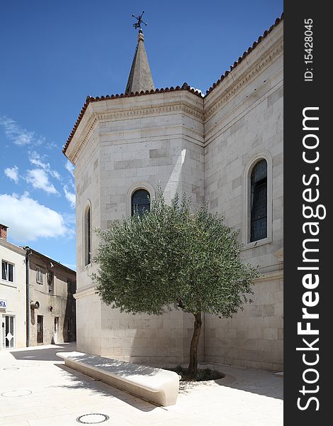 Modern stone bench with olive tree in Opuzen Croatia