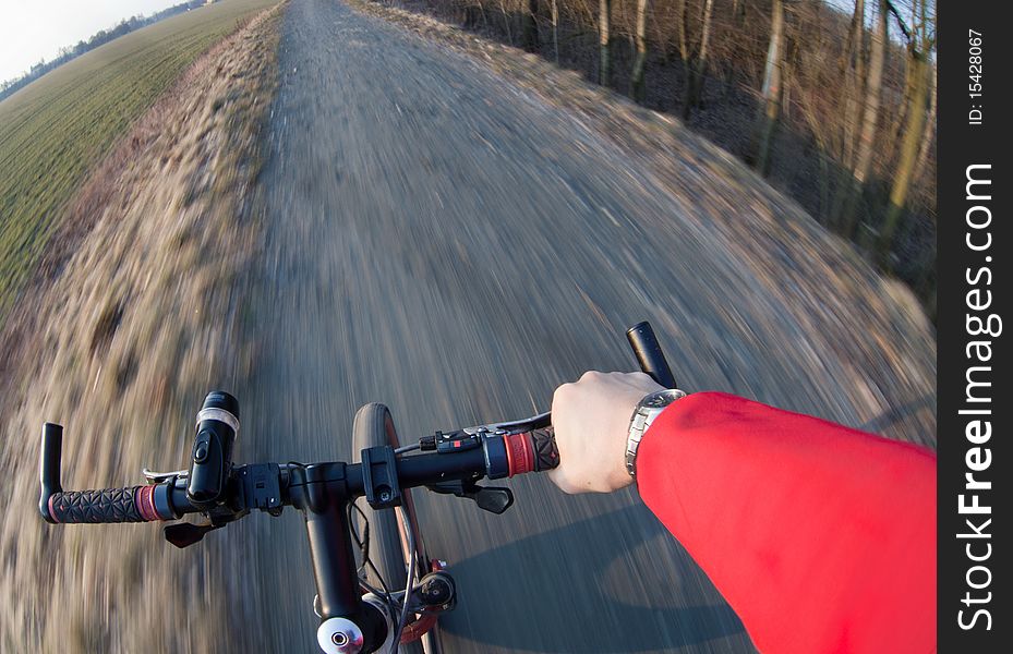 Riding a mountain bicycle on a country road (motion blurred image)