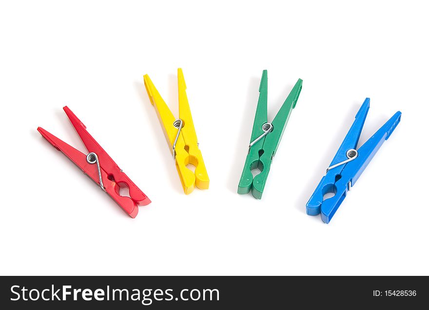 Color clothes pegs on a white background