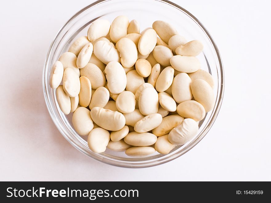 Cup with raw beans on isolated background