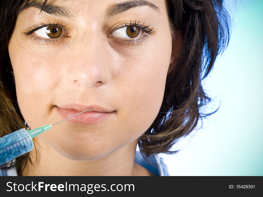 Beautiful woman recieving a botox injection in her lip