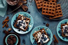 Chocolate Belgian Waffles With Ice Cream And Fresh Blueberry On Blue Background Royalty Free Stock Image