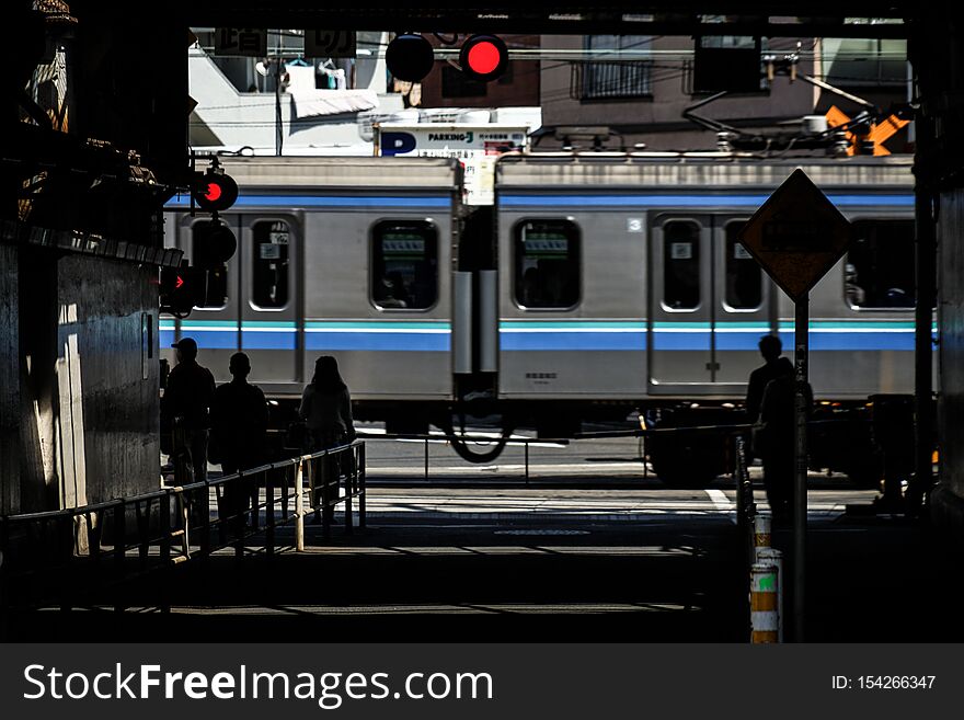 People waiting for the passage of a train. Shooting location :  Tokyo metropolitan area