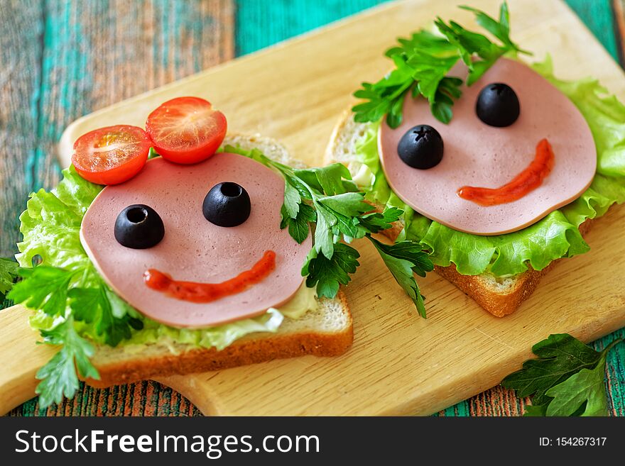 Close up of funny sandwiches the faces of a girl and a boy for a school lunch. Concept back to school.