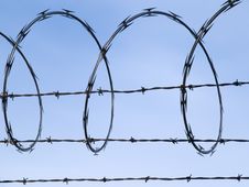 Barbed Wire Fence Against Blue Sky Stock Photo Barbed Wire Fence Against Blue Sky Stock Photo