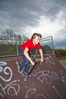 Boy Going Airborne With A Scooter Royalty Free Stock Photography
