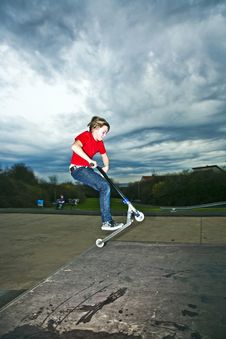 Boy Going Airborne With A Scooter Royalty Free Stock Photography