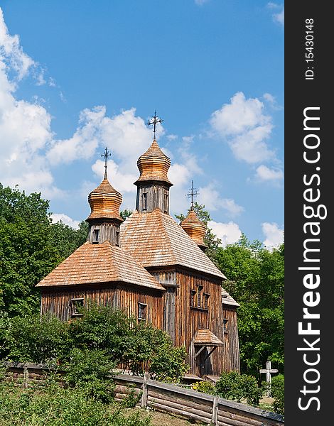 Old wooden church against summer cloudy sky, Ukraine.
