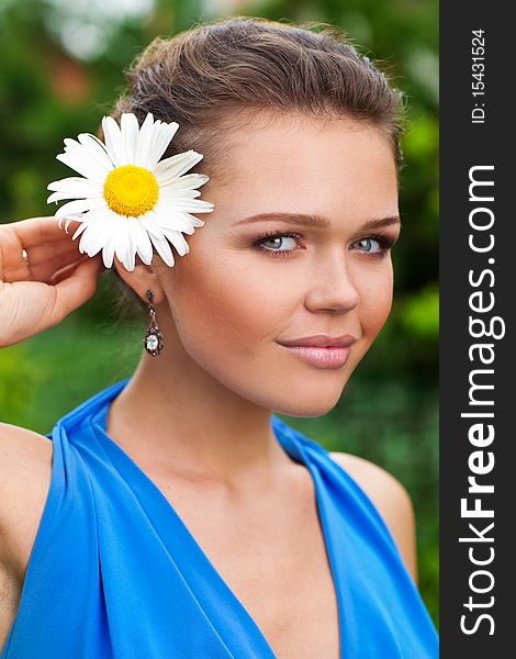 Pretty caucasian woman with flower looking at camera and smile. Pretty caucasian woman with flower looking at camera and smile