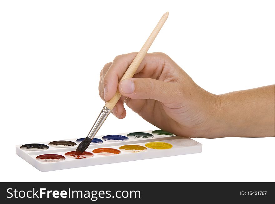 Watercolors and hand with a paintbrush on a white background