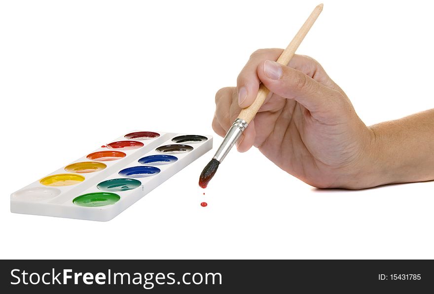 Watercolors and hand with a paintbrush on a white background